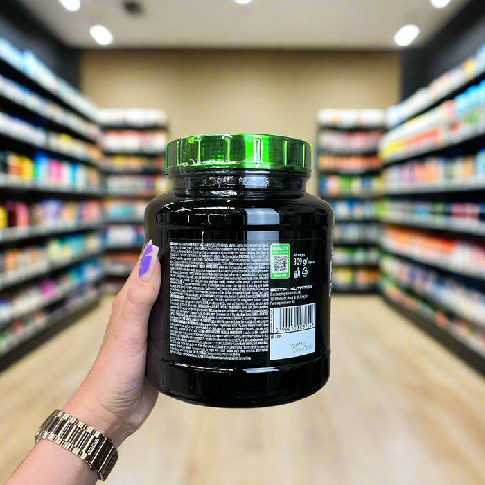 Close-up of (SciTec Multi Pro Plus - 30 packets) held up inside My Supplement Shop, clearly showing key ingredients on the packaging in a Sports Nutrition setting.